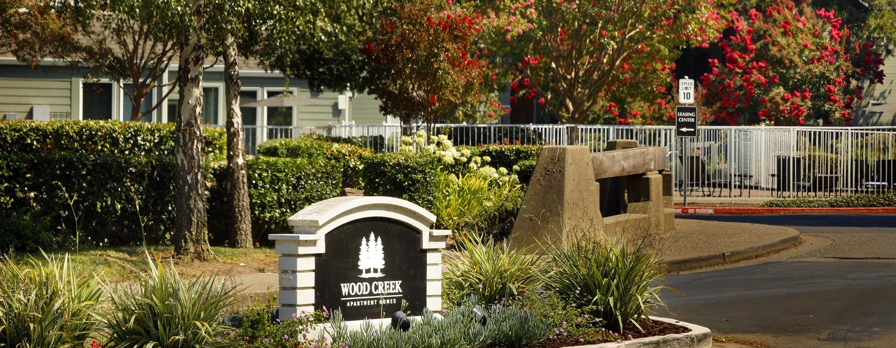 a sign in the street thats reads wood creek