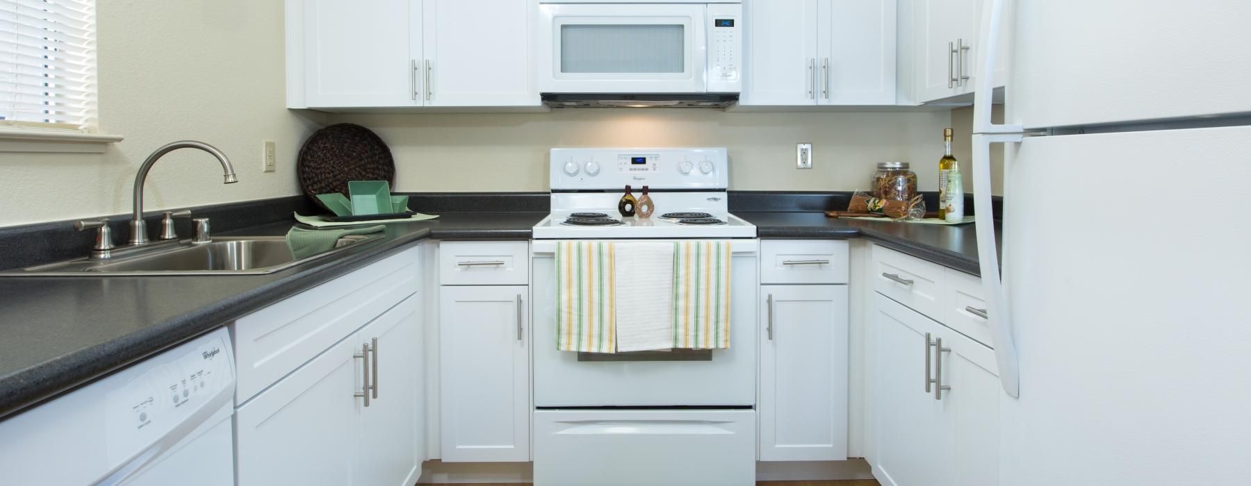 a kitchen with white cabinets
