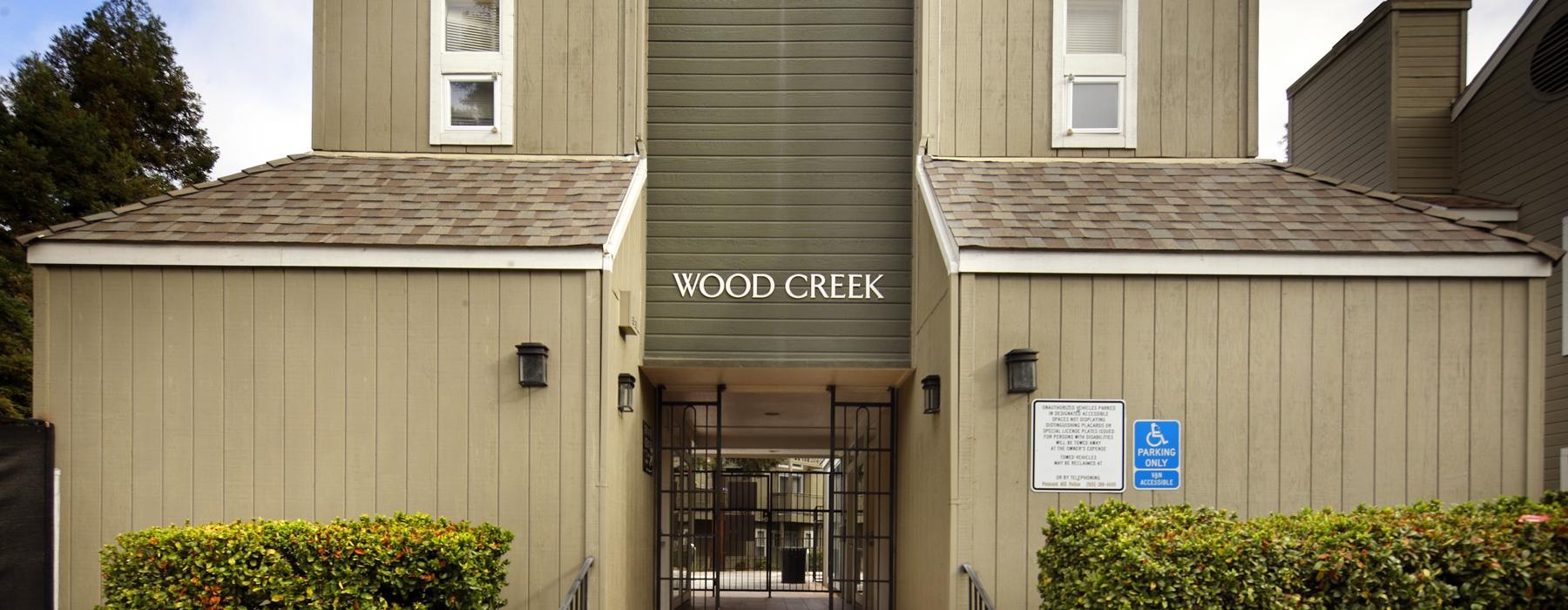 a building with a sign on the front that reads wood creek